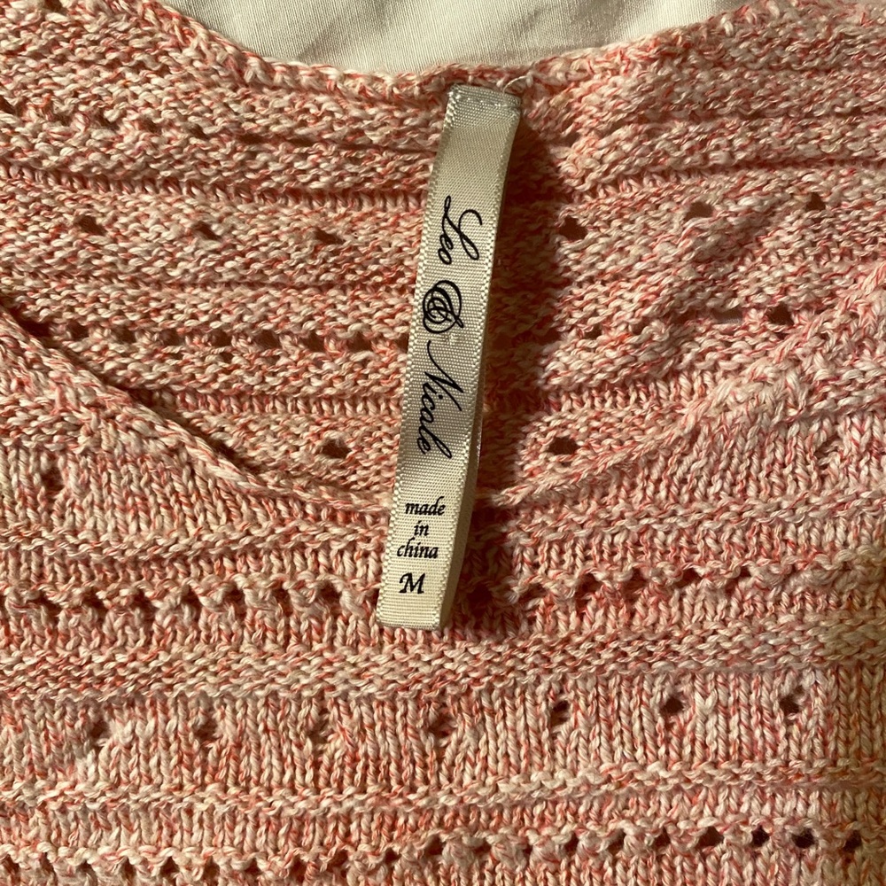 Pink knitted sweater.